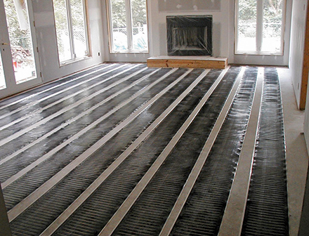 Low-voltage heating mats laid out.