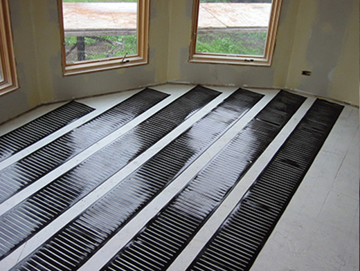 Low-voltage heating elements being installed for a heated floor.